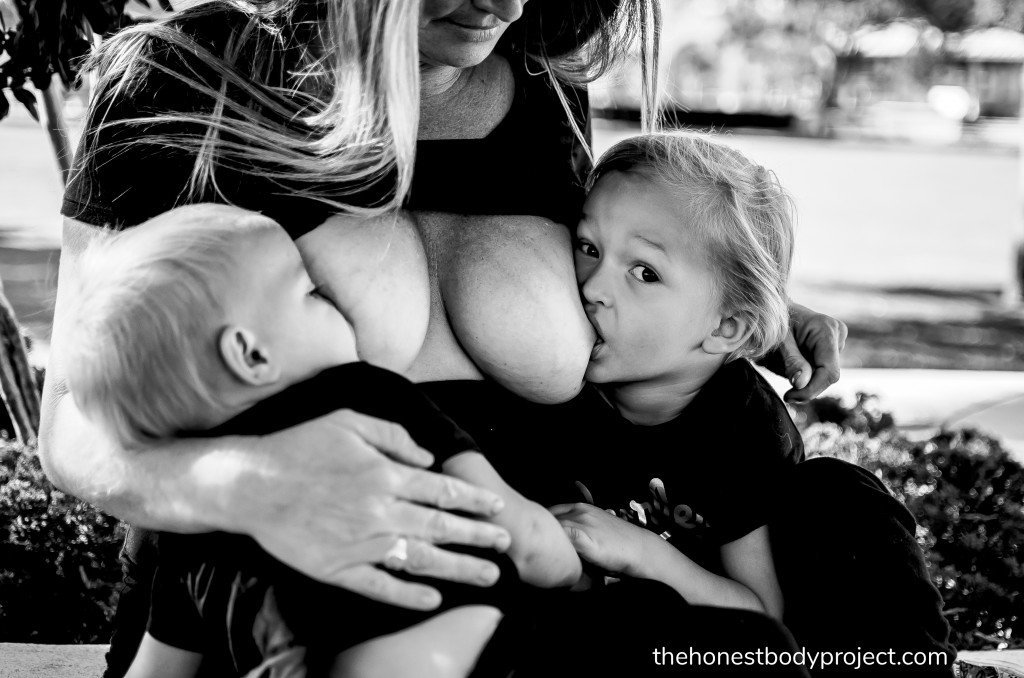 Women breastfeeding each other
